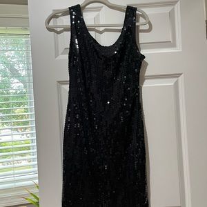 Cute unlined sequin mini dress. It has a scoop neck and back.